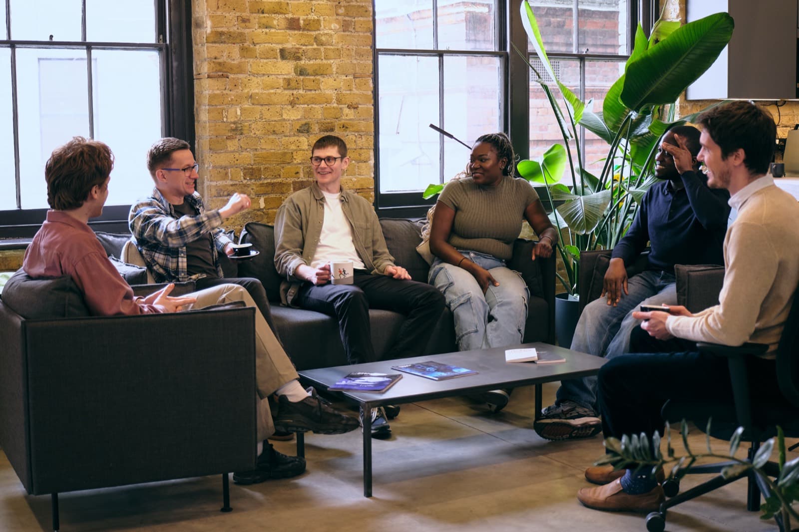 People talking on sofas in the Pixie Labs studio lounge